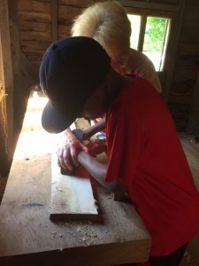 Shaving wood at London Town and Gardens